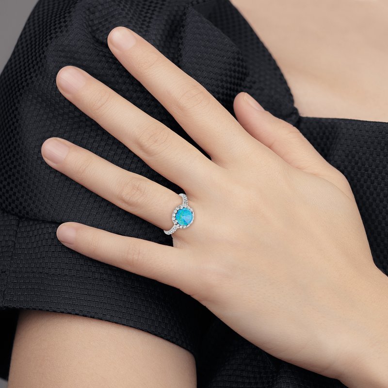 Sterling Silver Rhodium-plated Cabochon Lab Created Blue Opal and Brilliant Cut CZ Halo with Side Stones Ring